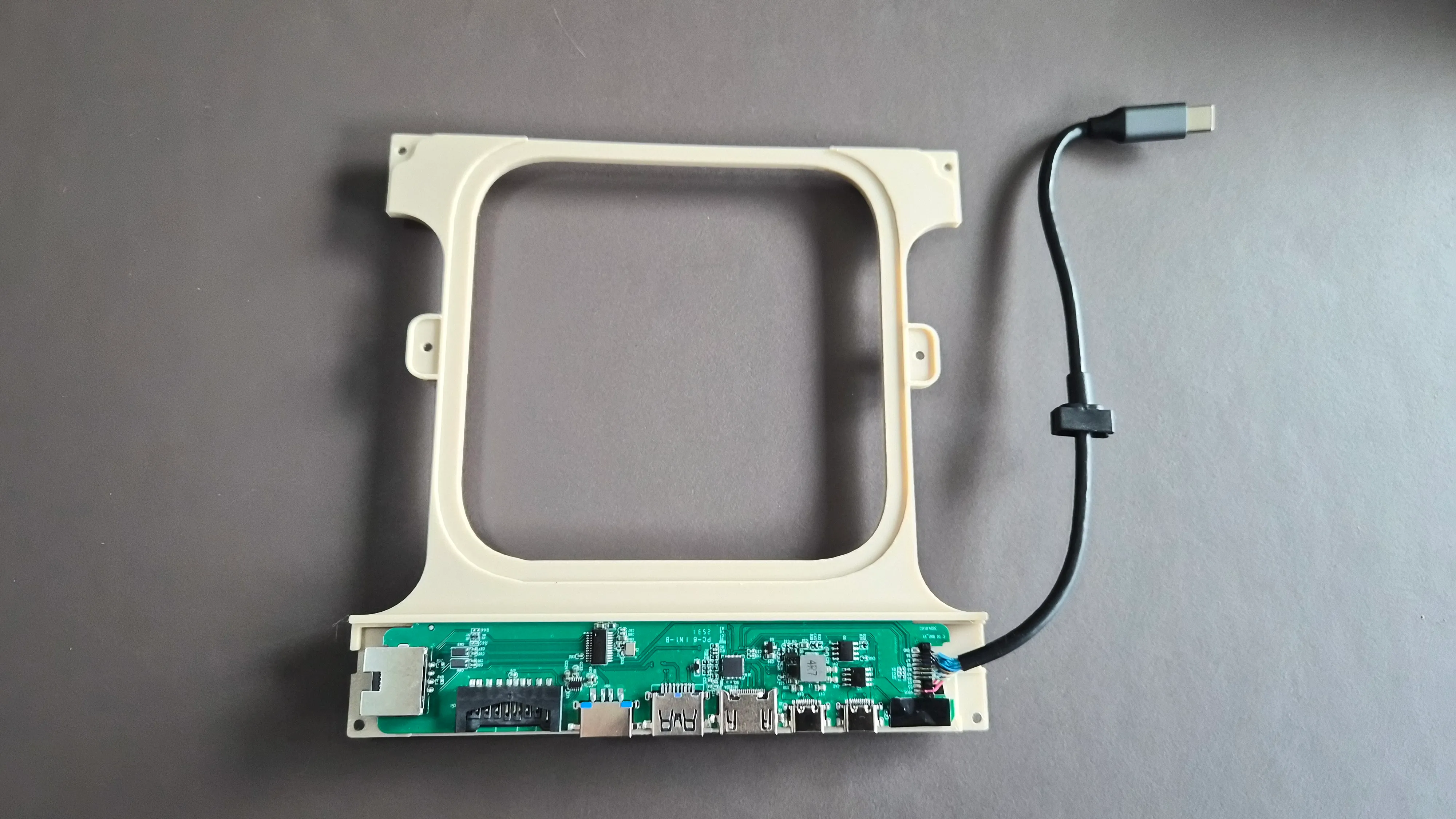 Remove the PCB of the USB-hub by pulling the black part around the ethernet-port sideways.