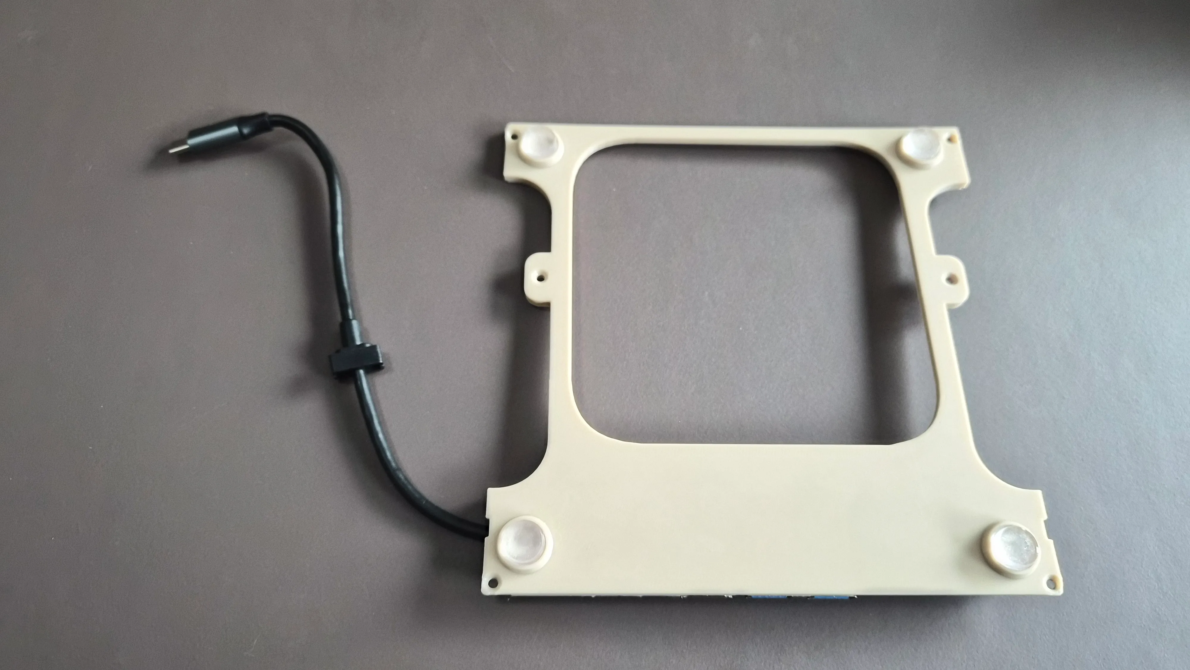 To raise the Mac mini a bit and improve the airflow, you can attach the four circular discs with some glue.