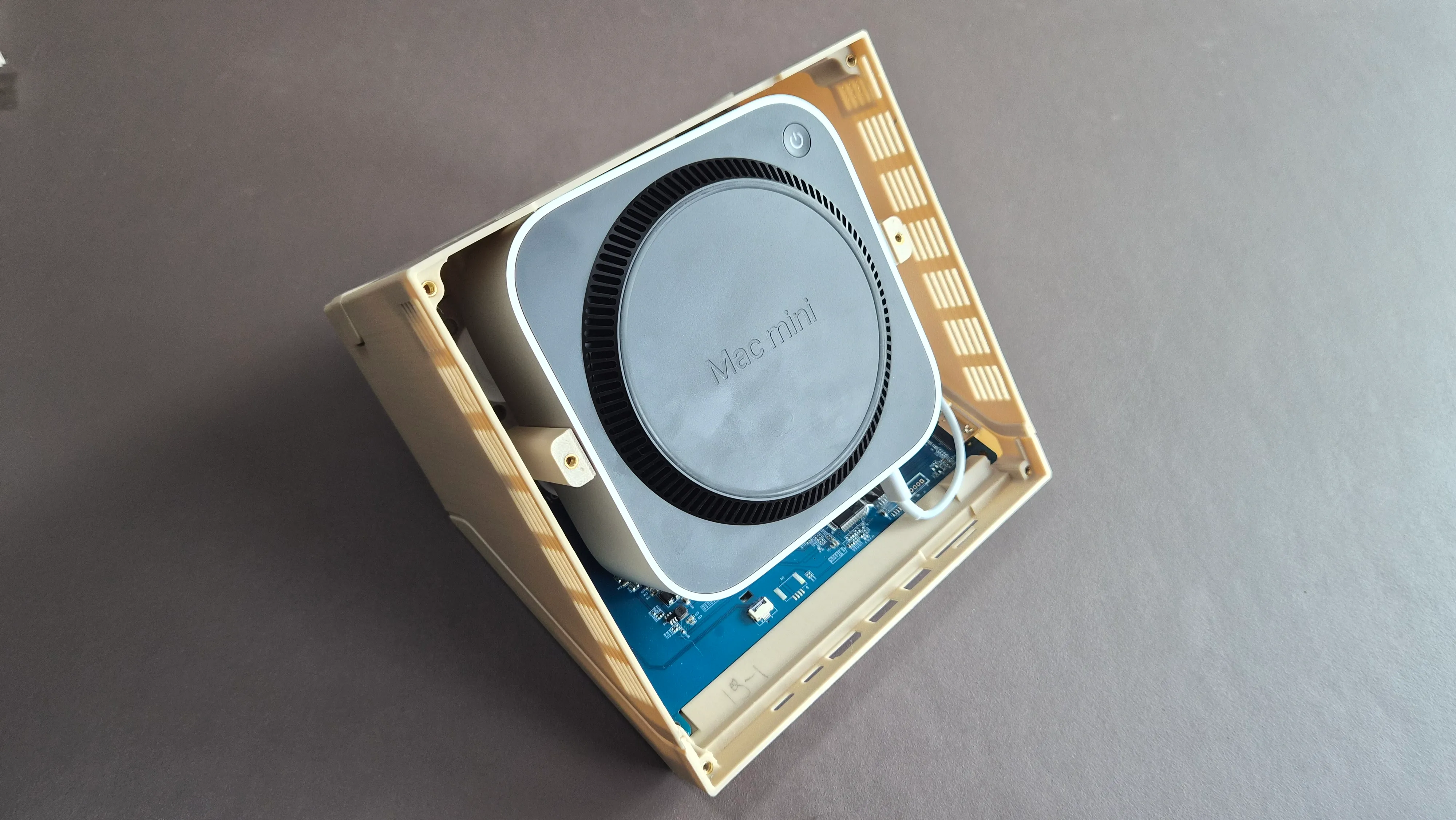 Place the case upside down and gently insert the Mac mini.